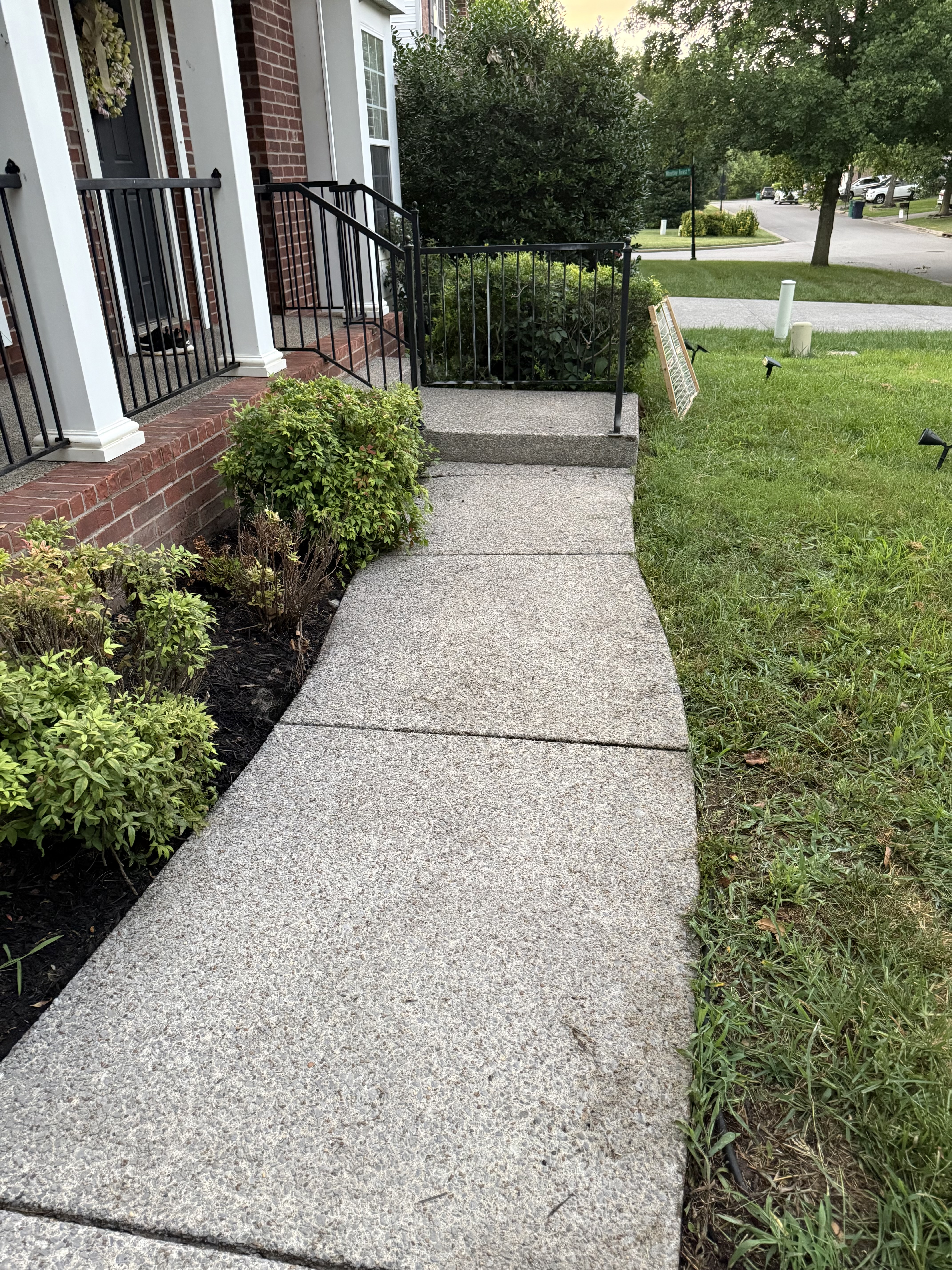 After pressure washing a brighter residential sidewalk